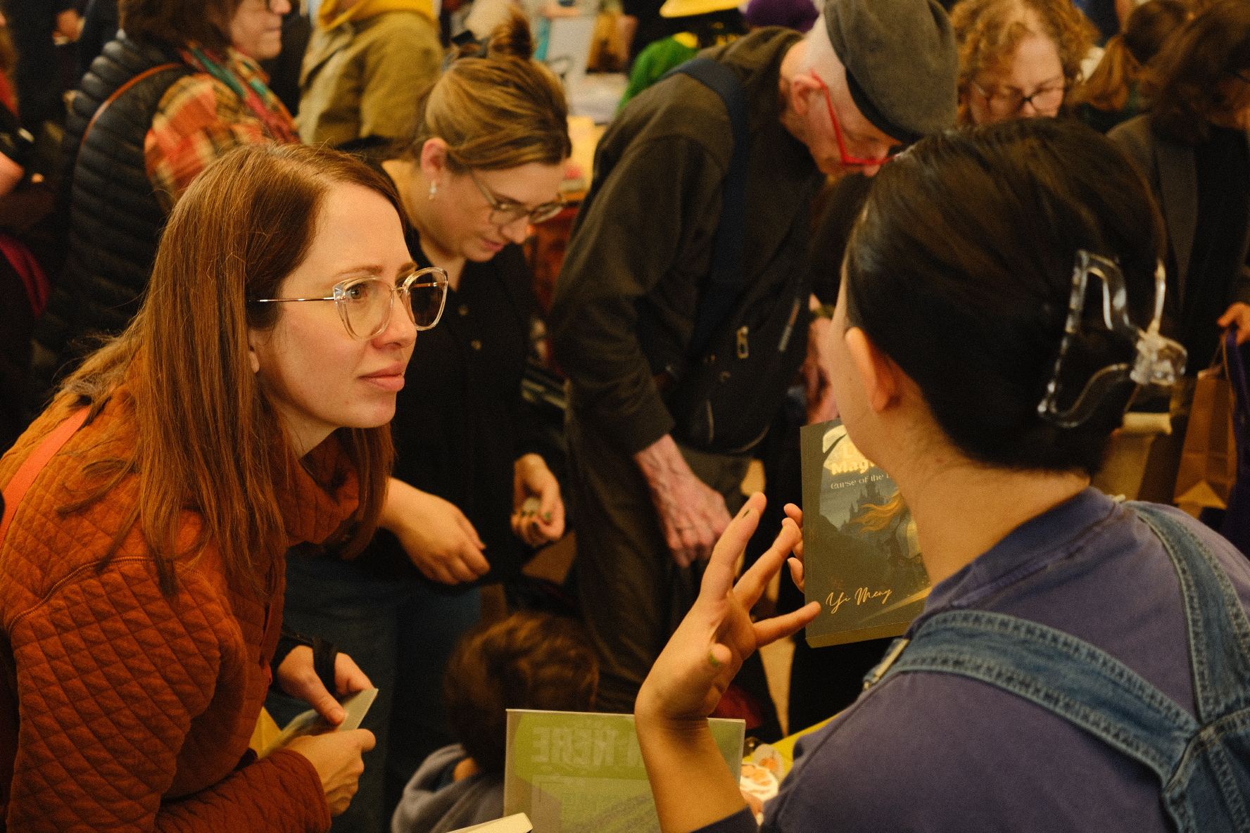 Talking through a picture book with a reader at the stand